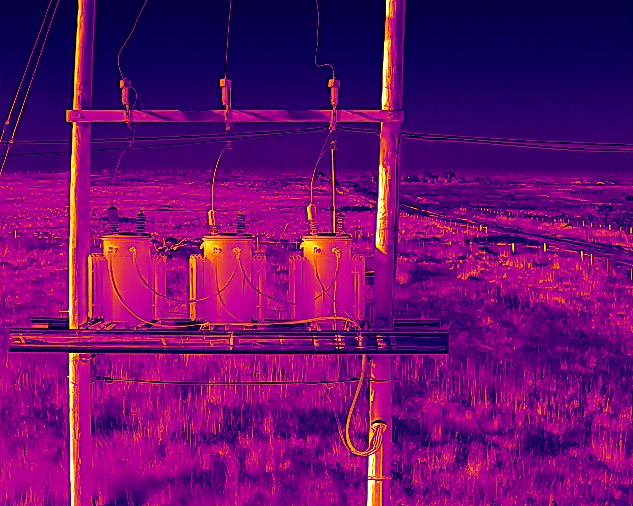 Aerial thermal image — Three-phase pole-mounted transformer bank on rural distribution line
